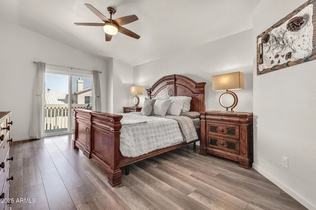 a bedroom with bed and wooden floor