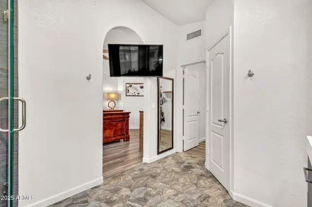 a view of walk in closet with clothes and shoes