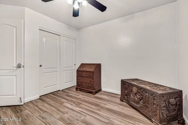 a bathroom with a granite countertop sink a toilet and a mirror