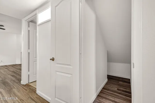 a bedroom with a bed and a dresser next to a window