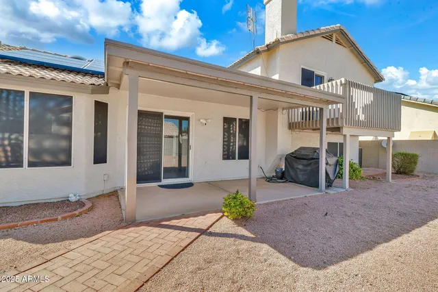 a view of a house with a backyard and plants