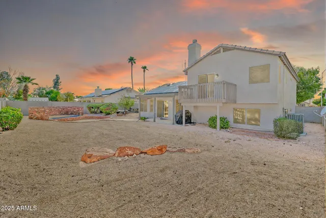 a row of car parked in parking lot of house