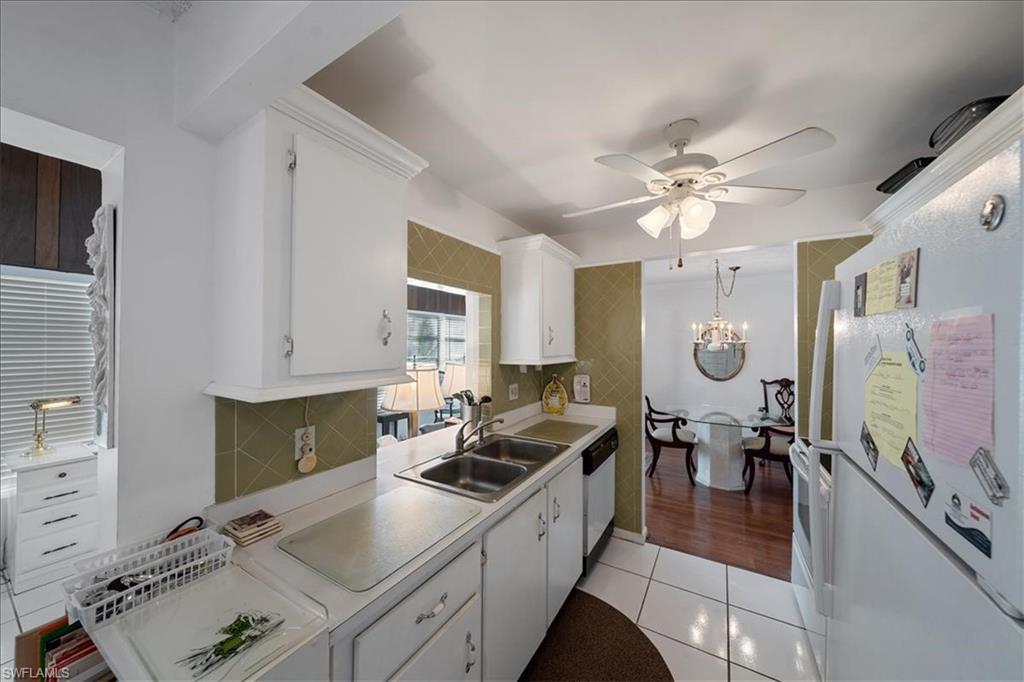 1069 Forest Lakes Drive, Unit 1B Naples, FL 34105 - Photo 12 of 29 a kitchen with granite countertop a sink appliances and cabinets