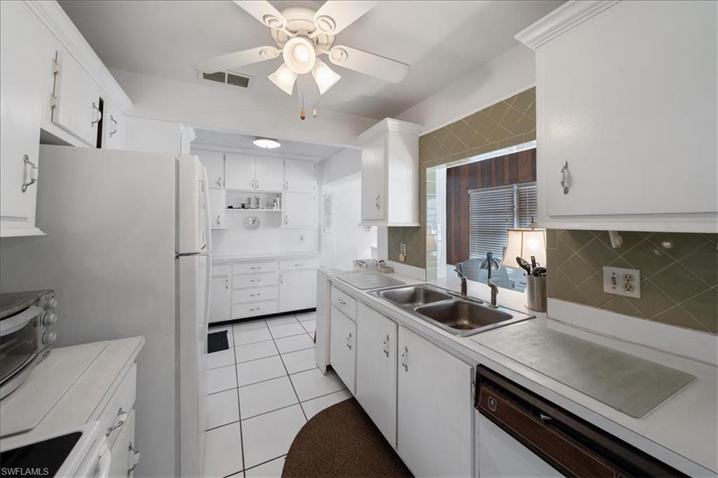 1069 Forest Lakes Drive, Unit 1B Naples, FL 34105 - Photo 14 of 29 a kitchen with a sink appliances and cabinets