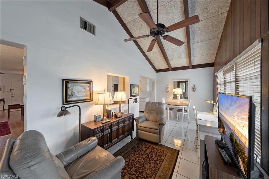 1069 Forest Lakes Drive, Unit 1B Naples, FL 34105 - Photo 19 of 29 a living room with furniture and a rug