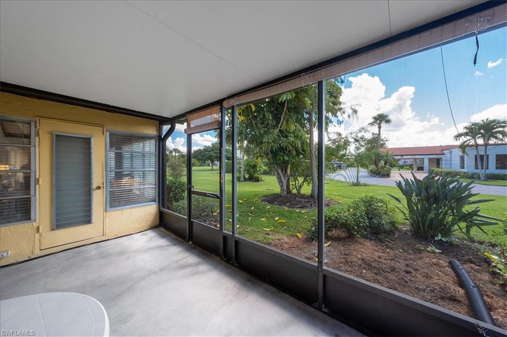 1069 Forest Lakes Drive, Unit 1B Naples, FL 34105 - Photo 24 of 29 a view of a porch with a floor to ceiling window and an entrance