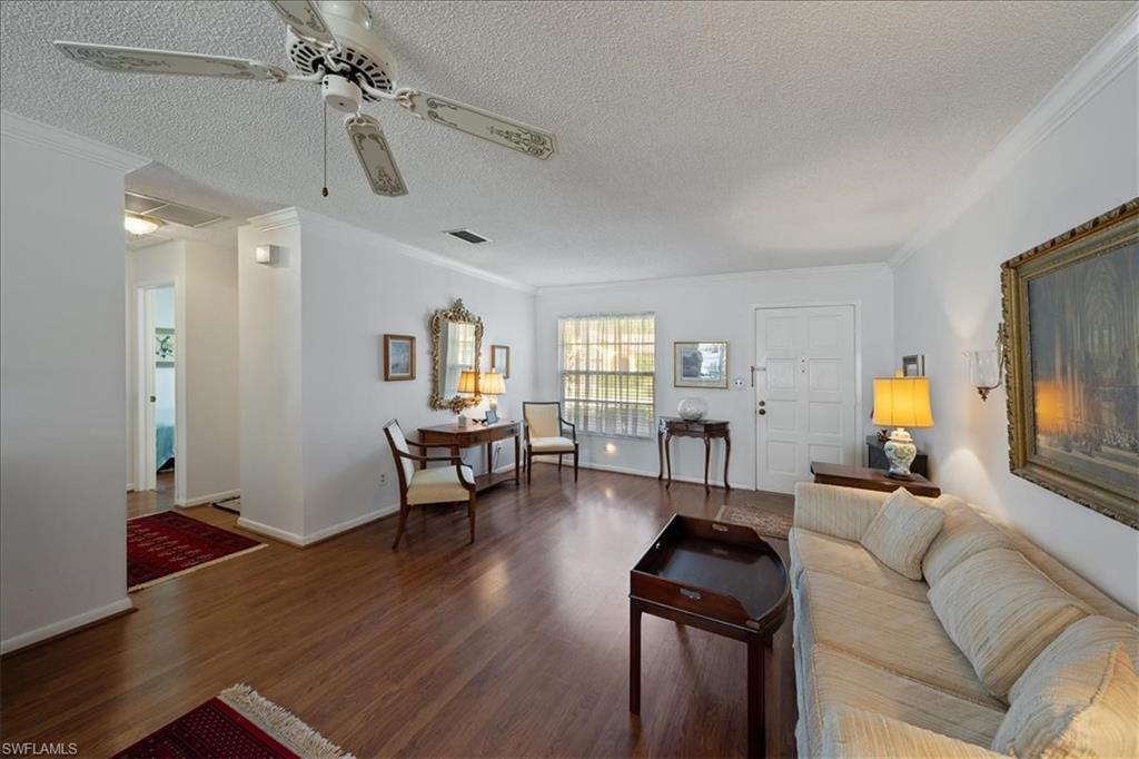 1069 Forest Lakes Drive, Unit 1B Naples, FL 34105 - Photo 6 of 29 a living room with furniture and a flat screen tv