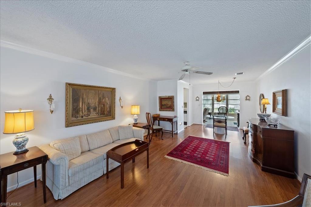 1069 Forest Lakes Drive, Unit 1B Naples, FL 34105 - Photo 7 of 29 a living room with furniture and wooden floor