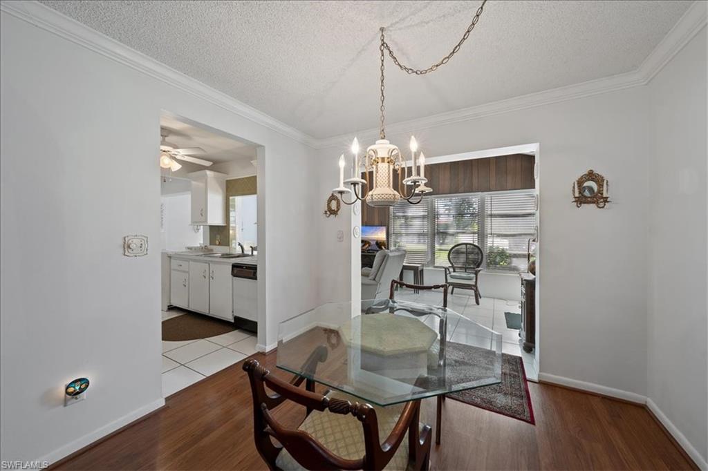 1069 Forest Lakes Drive, Unit 1B Naples, FL 34105 - Photo 10 of 29 a dining room with furniture and window