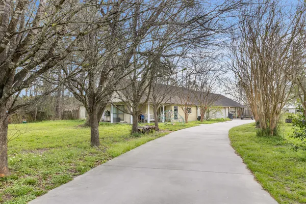a front view of house with yard and green space