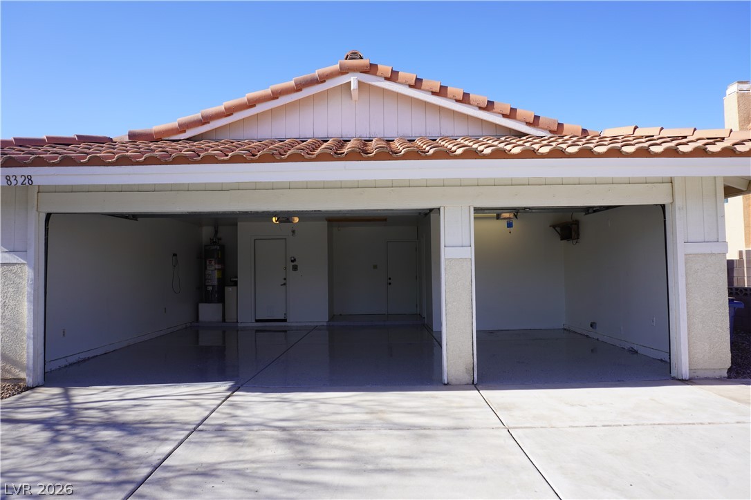 8328 Del Rey Avenue Las Vegas, NV 89117 - Photo 7 of 38 A spacious three-car garage offers ample parking and storage with a durable, finished floor.