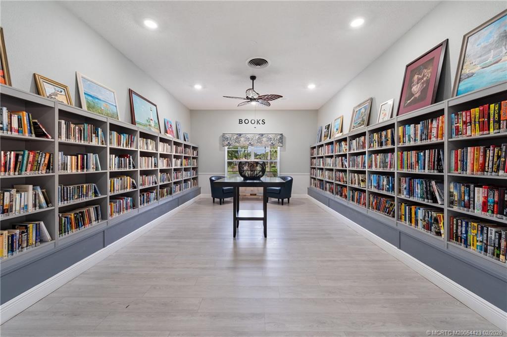 1903 Southwest Palm City Road, Unit C Stuart, FL 34994 - Photo 20 of 34 a living room with a book shelf and a book shelf