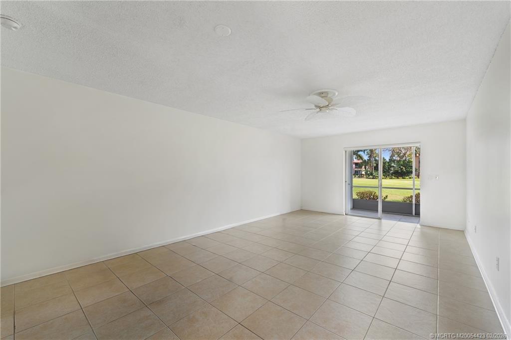 1903 Southwest Palm City Road, Unit C Stuart, FL 34994 - Photo 2 of 34 an empty room with windows and fan