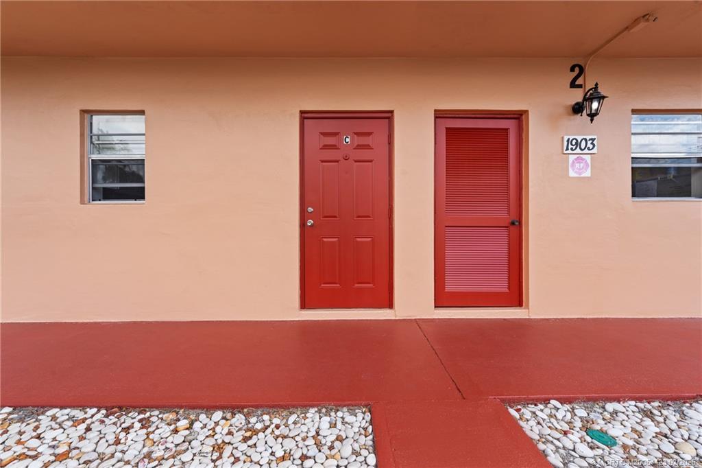 1903 Southwest Palm City Road, Unit C Stuart, FL 34994 - Photo 25 of 34 a view of a livingroom with a bookshelf