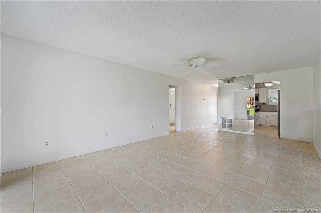 1903 Southwest Palm City Road, Unit C Stuart, FL 34994 - Photo 28 of 34 a view of a livingroom with wooden floor and a kitchen