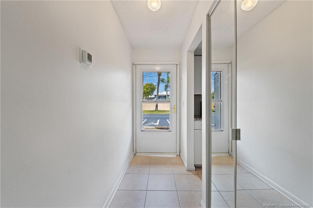 1903 Southwest Palm City Road, Unit C Stuart, FL 34994 - Photo 4 of 34 a view of a hallway with wooden shelves