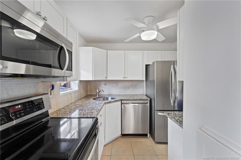 1903 Southwest Palm City Road, Unit C Stuart, FL 34994 - Photo 5 of 34 a kitchen with a sink and stainless steel appliances
