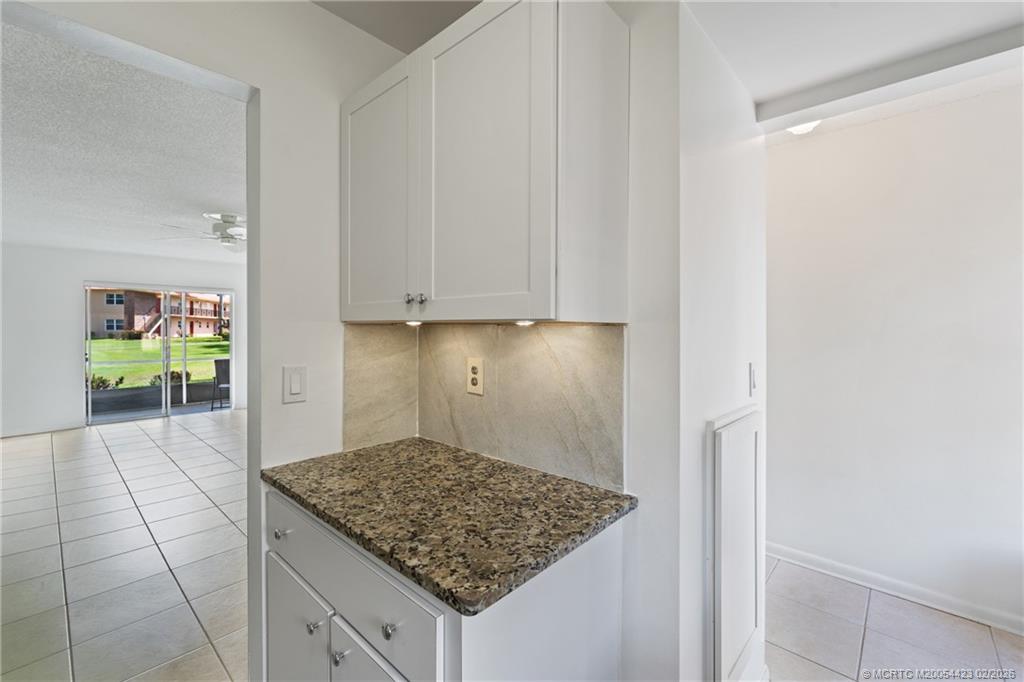 1903 Southwest Palm City Road, Unit C Stuart, FL 34994 - Photo 7 of 34 a kitchen with white cabinets and a window