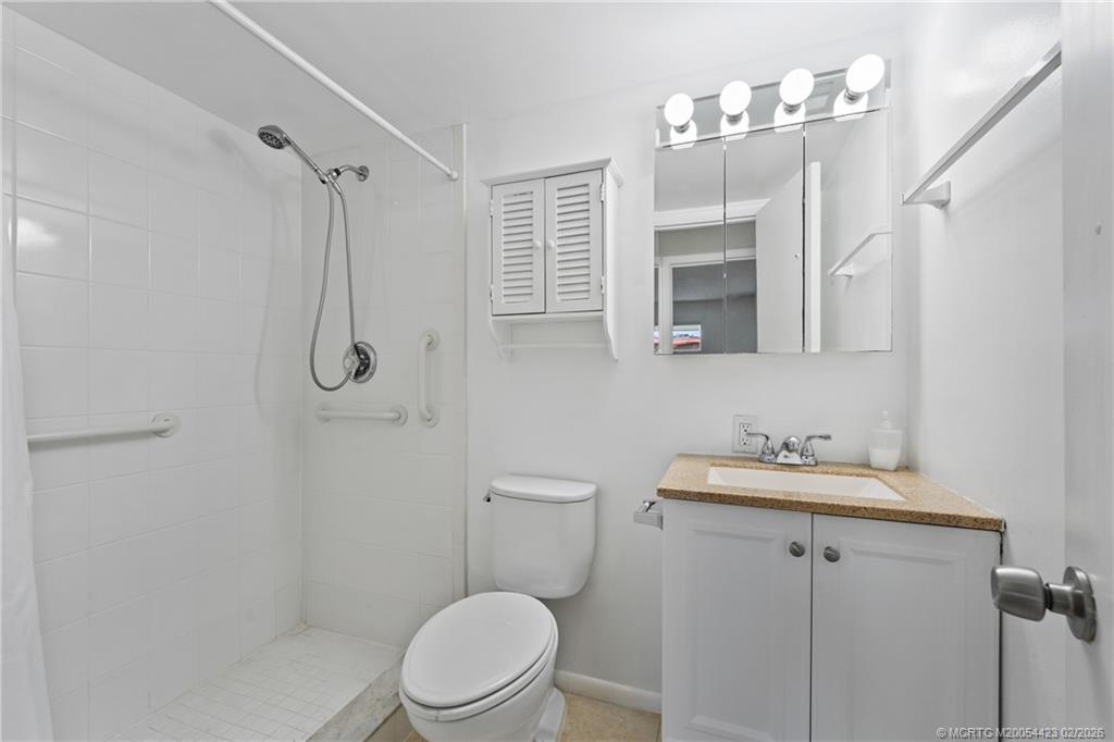 1903 Southwest Palm City Road, Unit C Stuart, FL 34994 - Photo 10 of 34 a bathroom with a sink a toilet and shower