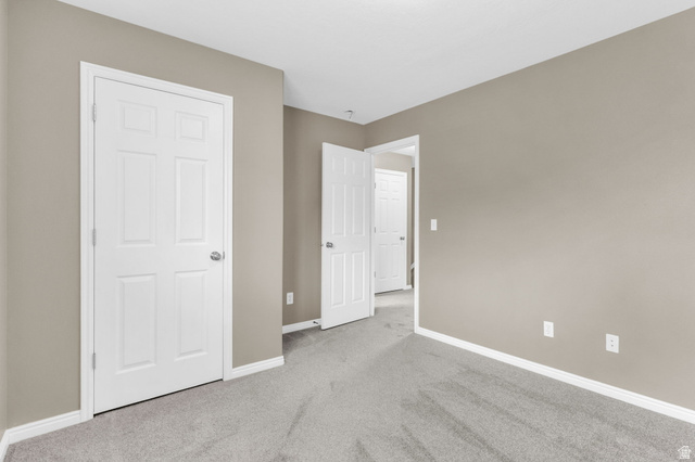 656 South 910 West, Unit 25 Pleasant Grove, UT 84062 - Photo 22 of 25 Neutral-toned room with plush grey carpeting and white baseboards.