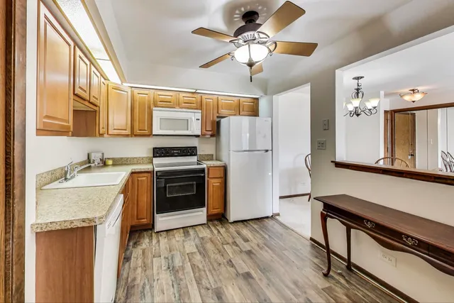a kitchen with a stove a sink and a refrigerator
