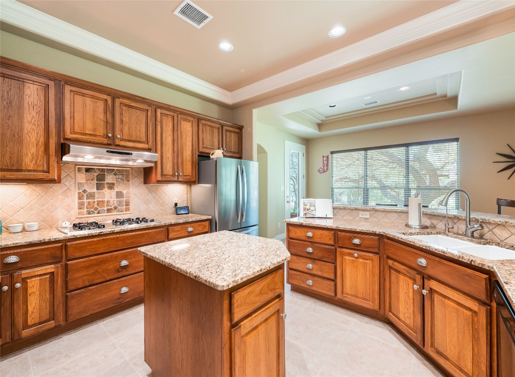 104 East Rustle Cove Georgetown, TX 78628 - Photo 14 of 40 a kitchen with a sink stove and refrigerator
