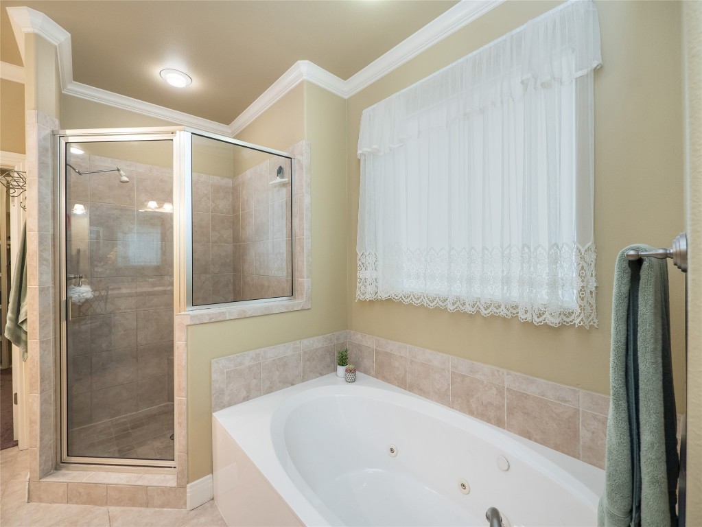 104 East Rustle Cove Georgetown, TX 78628 - Photo 20 of 40 a bathroom with a bathtub and a shower