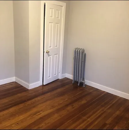 a view of wooden floor and closet in a room