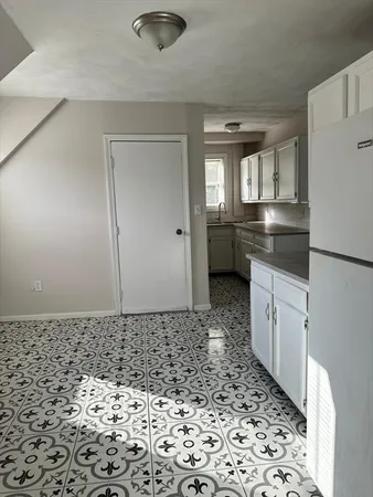 a bathroom with a granite countertop sink and a toilet