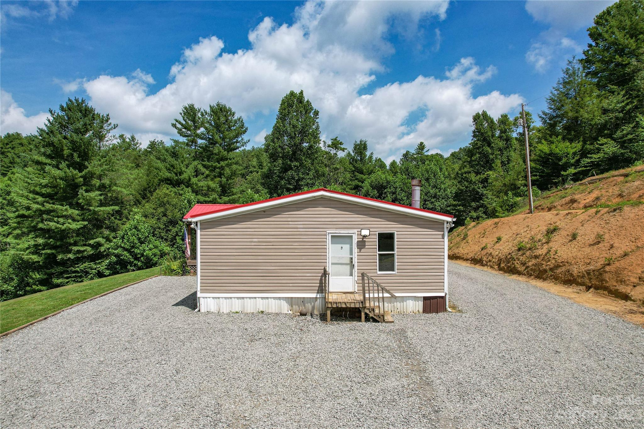 3113 Revere Road Marshall, NC 28753 - Photo 21 of 47 a view of a house with a yard and large tree