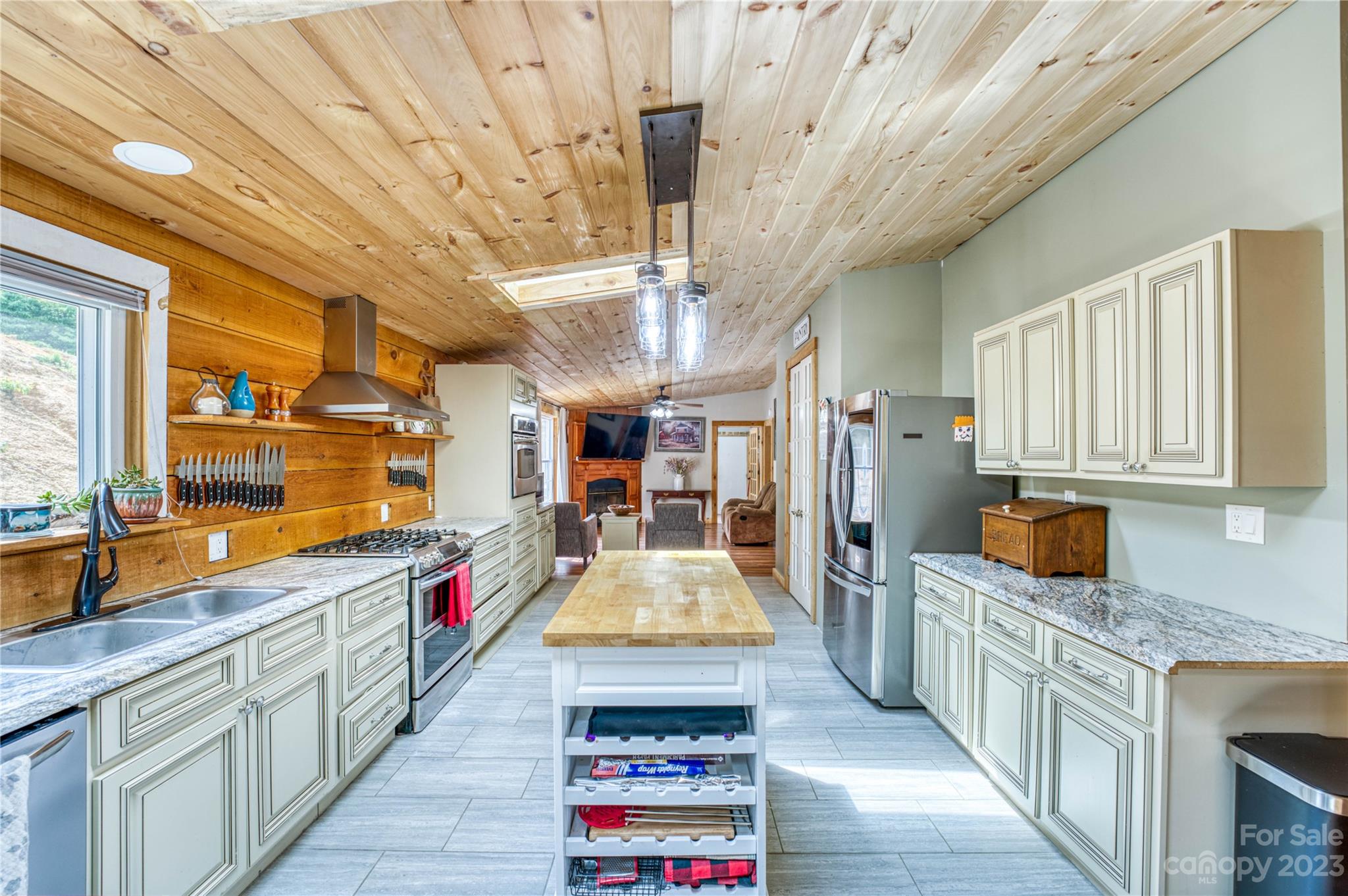 3113 Revere Road Marshall, NC 28753 - Photo 23 of 47 a kitchen with stainless steel appliances granite countertop a sink and wooden cabinets