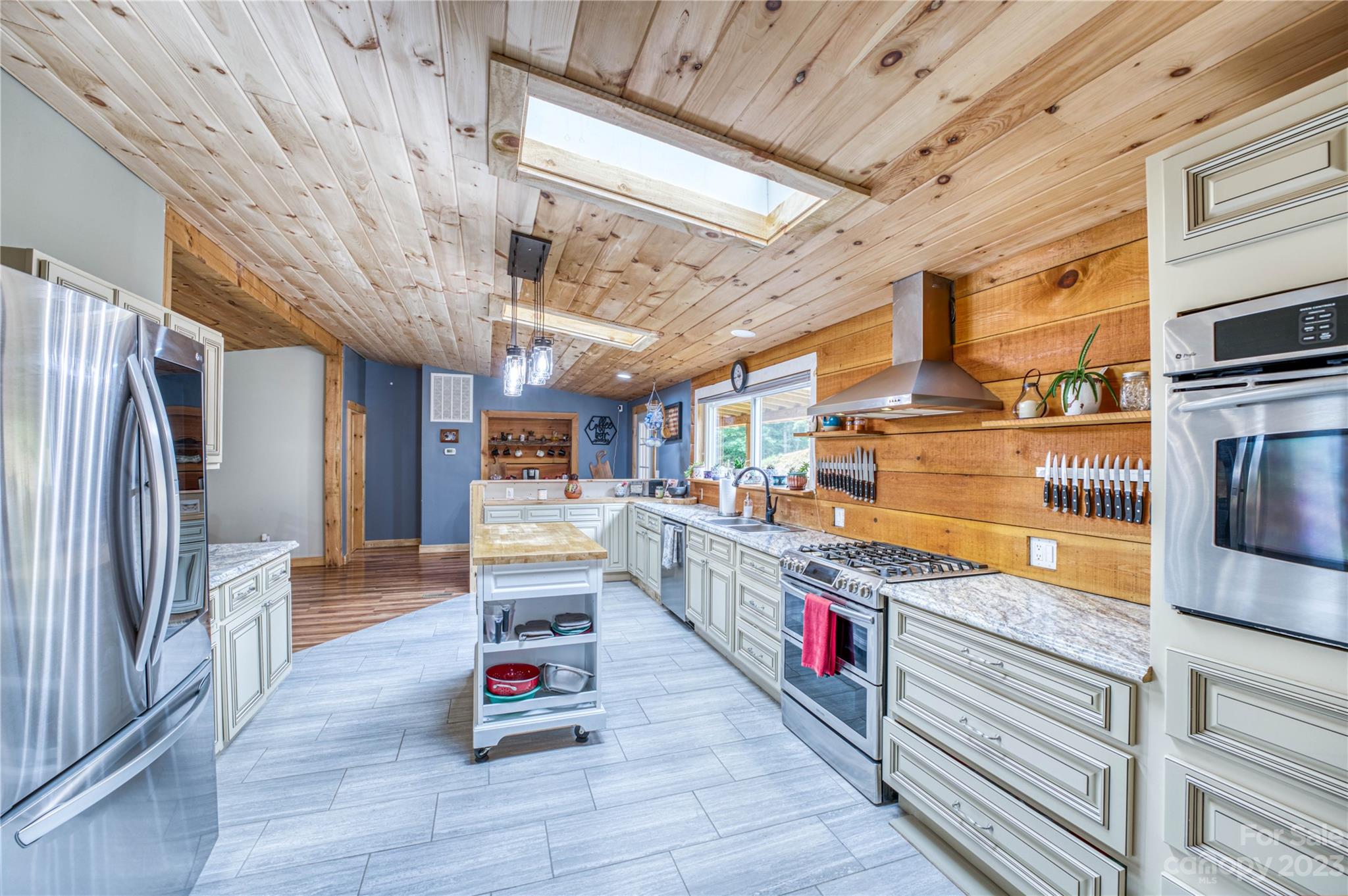 3113 Revere Road Marshall, NC 28753 - Photo 25 of 47 a kitchen with stainless steel appliances granite countertop a sink and wooden floors