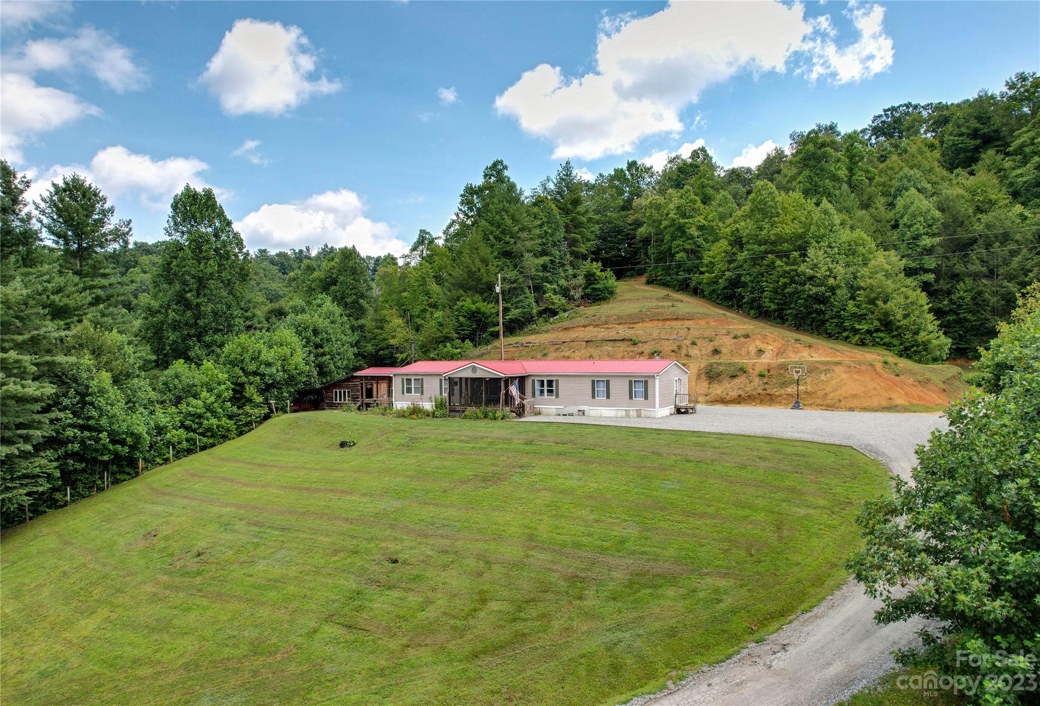 3113 Revere Road Marshall, NC 28753 - Photo 3 of 47 a backyard of a house with table and chairs
