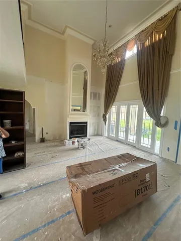 a spacious bedroom with a bed and a chandelier