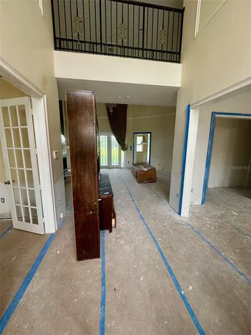 a view of a hallway with wooden floor and windows