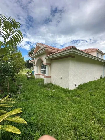 a house with swimming pool in front of it
