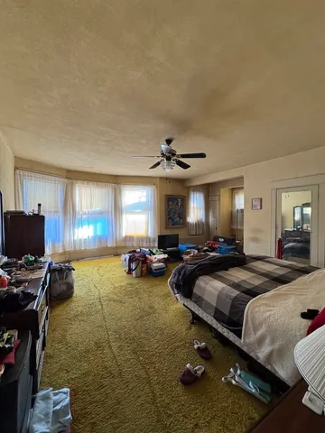 a living room with furniture and a gym machine