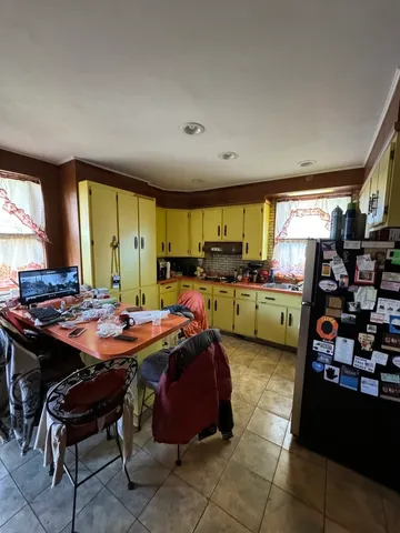 a view of a kitchen with dining table and chairs