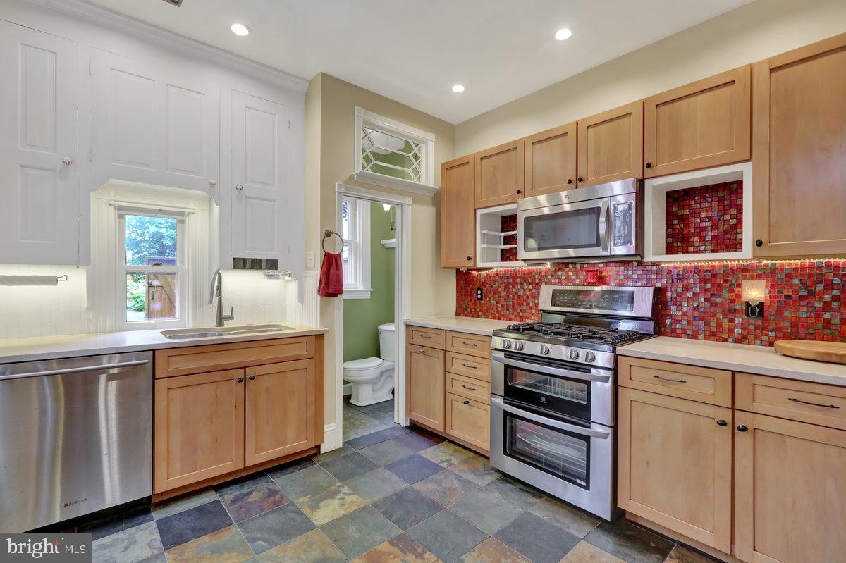 315 Nevin Street Lancaster, PA 17603 - Photo 16 of 41 a kitchen with stainless steel appliances a stove sink and cabinets