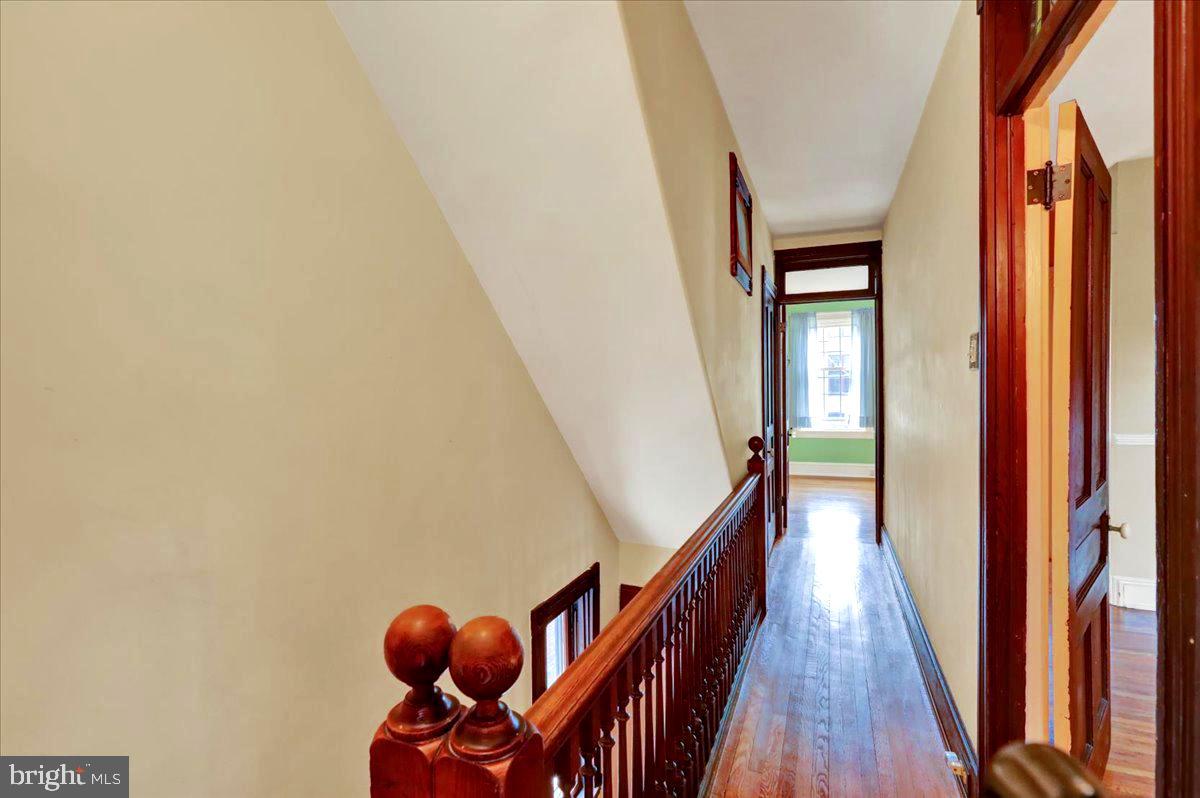 315 Nevin Street Lancaster, PA 17603 - Photo 19 of 41 a view of a hallway with wooden floor and stairs