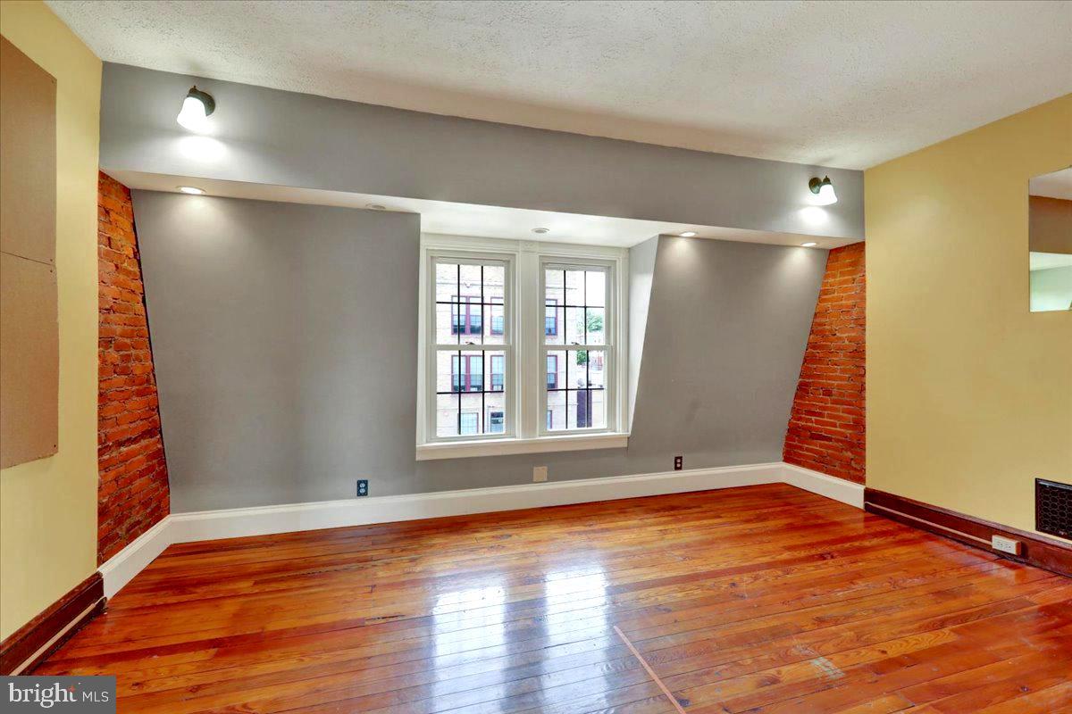 315 Nevin Street Lancaster, PA 17603 - Photo 34 of 41 a view of an empty room with wooden floor and a window