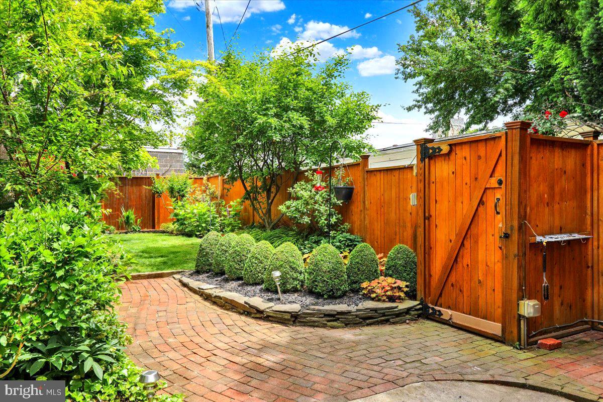 315 Nevin Street Lancaster, PA 17603 - Photo 36 of 41 a view of a backyard with potted plants and a large tree