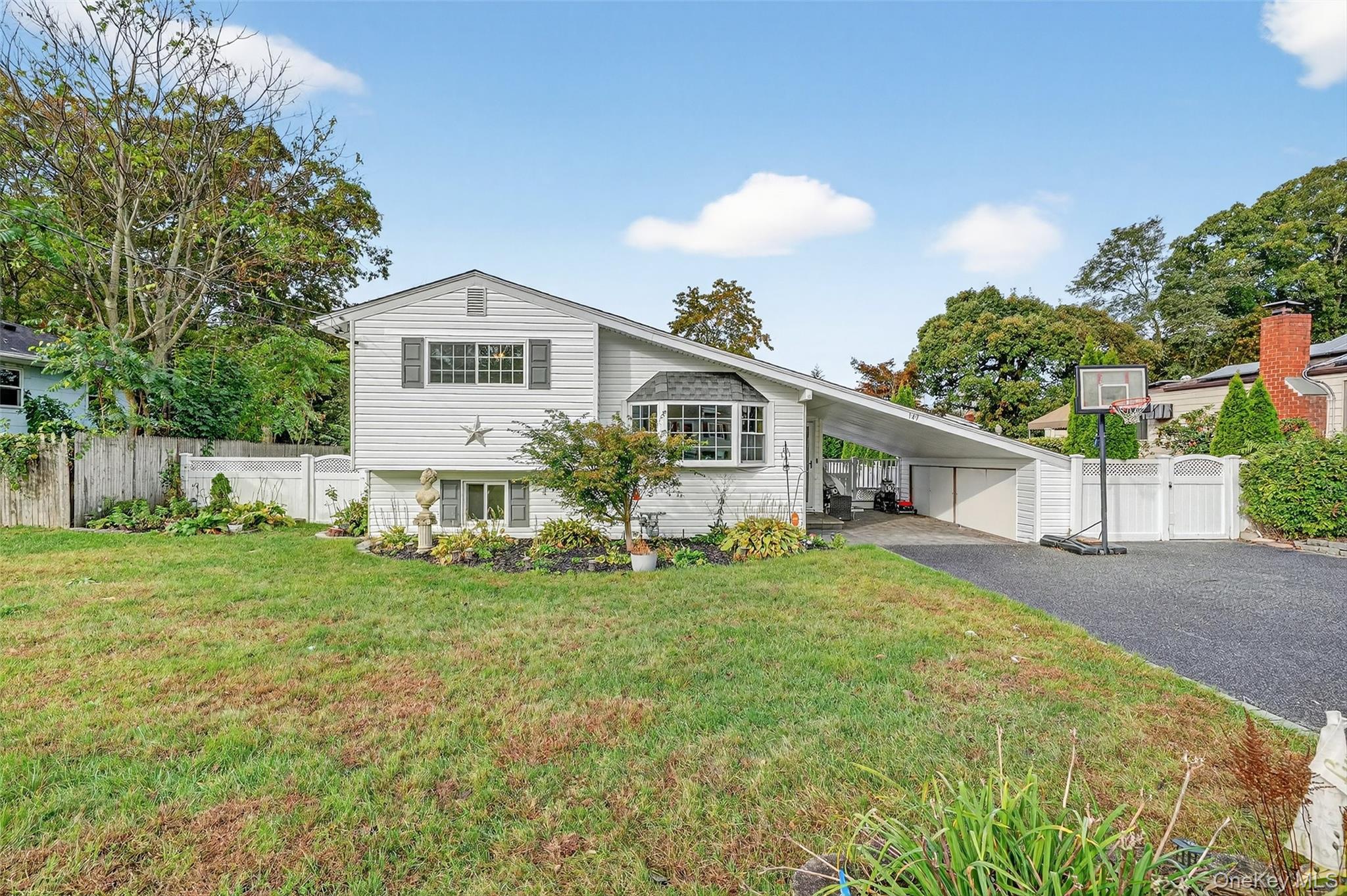 149 Tudor Road Centereach, NY 11720 - Photo 1 of 1 a front view of a house with a yard and trees