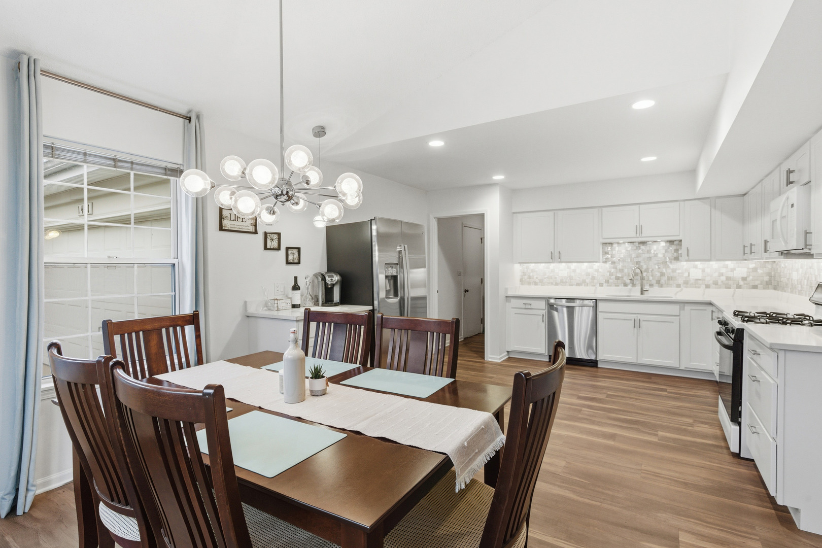 1411 Clybourne Street, Unit 11E Batavia, IL 60510 - Photo 2 of 34 a view of a dining room with furniture and wooden floor