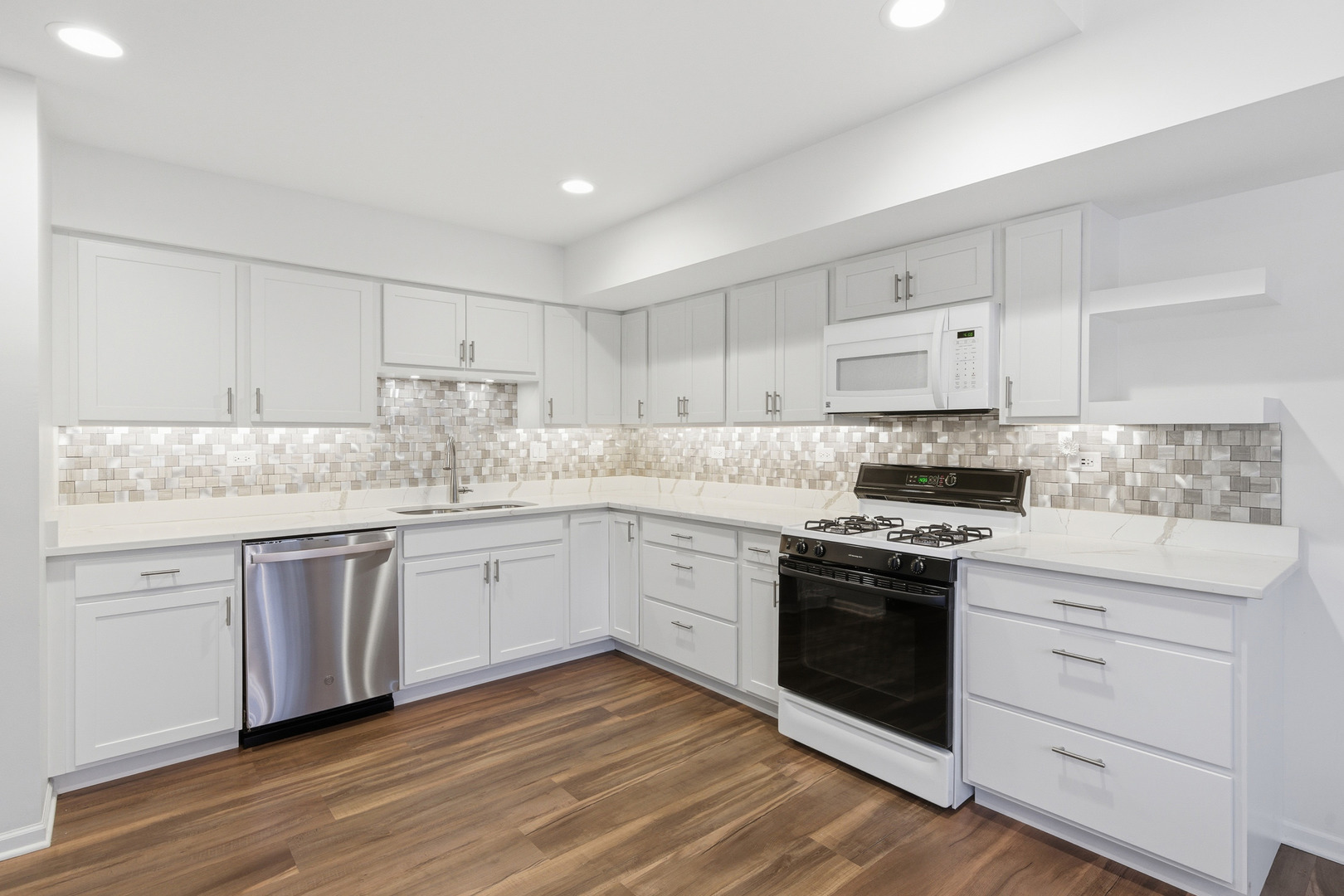 1411 Clybourne Street, Unit 11E Batavia, IL 60510 - Photo 3 of 34 a kitchen with granite countertop white cabinets and white appliances