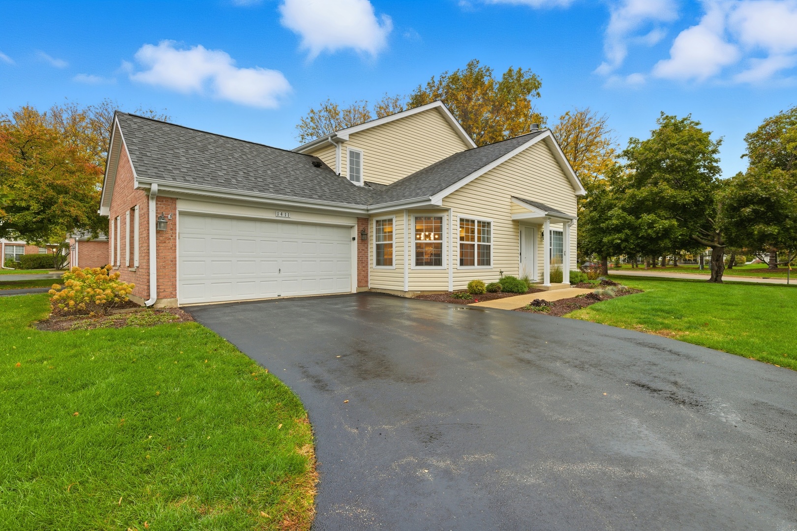 1411 Clybourne Street, Unit 11E Batavia, IL 60510 - Photo 34 of 34 a front view of a house with a yard and garage