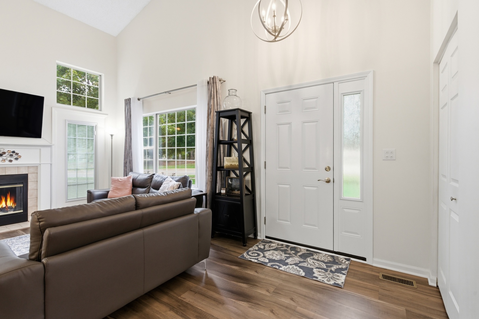 1411 Clybourne Street, Unit 11E Batavia, IL 60510 - Photo 6 of 34 a living room with furniture a flat screen tv and a fireplace