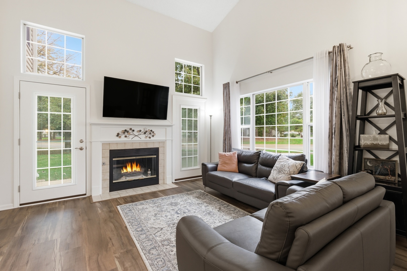 1411 Clybourne Street, Unit 11E Batavia, IL 60510 - Photo 8 of 34 a living room with furniture a flat screen tv and a fireplace