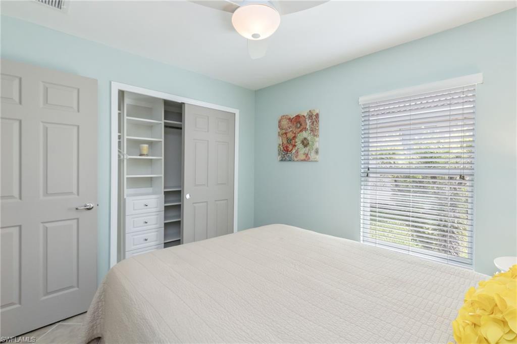 5801 Declaration Court Ave Maria, FL 34142 - Photo 19 of 38 a bedroom with a bed and a window