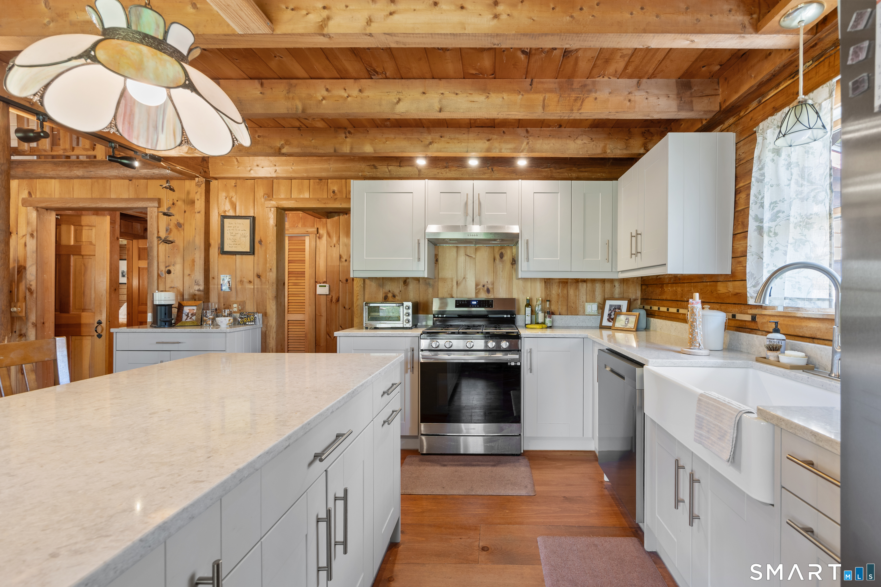 622 Chestnut Ridge Road Orange, CT 06477 - Photo 8 of 40 Step into this stunning, modern gourmet kitchen, boasting crisp white Shaker cabinets, durable Quartz countertops, sleek stainless steel appliances, and an exquisite Farmhouse sink.